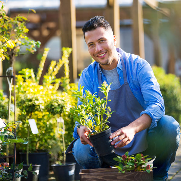 man posing with a plant in hand